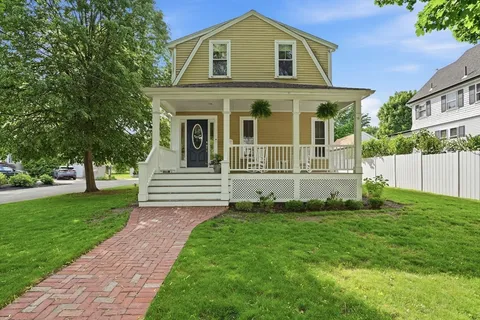 a front view of a house with a garden