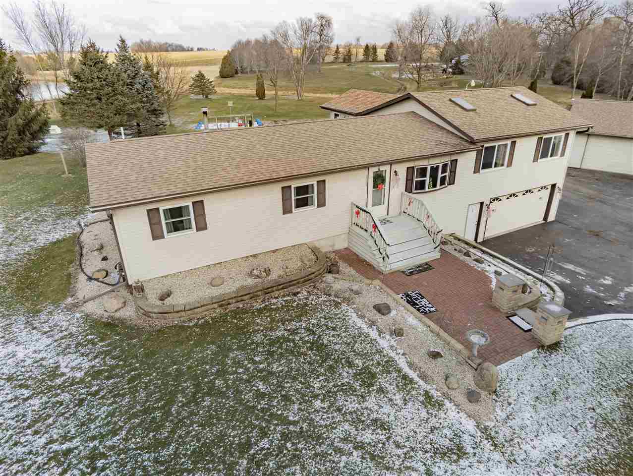 an aerial view of a house with a yard