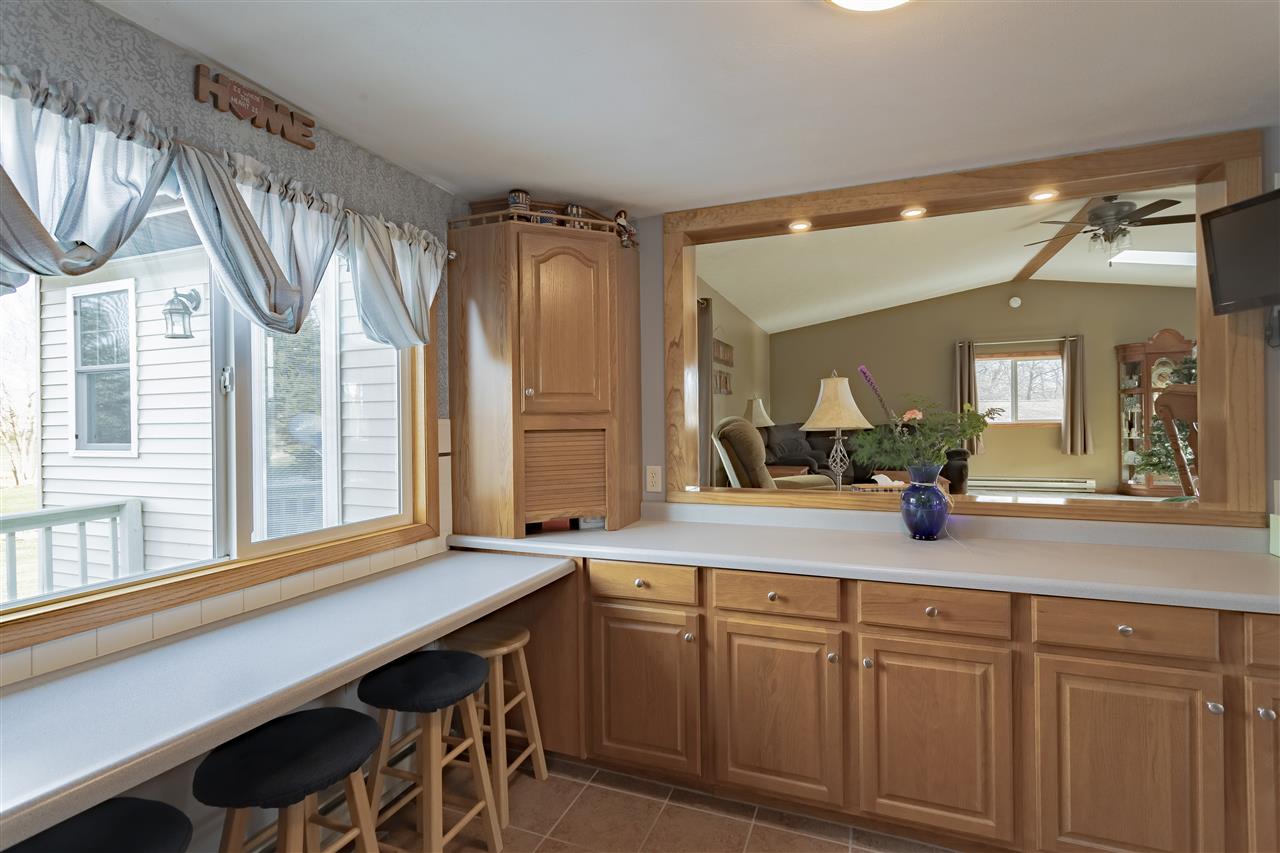 9119 Montague Road Winnebago, IL 61088 - Photo 11 of 36 a spacious bathroom with a granite countertop sink a mirror and a shower