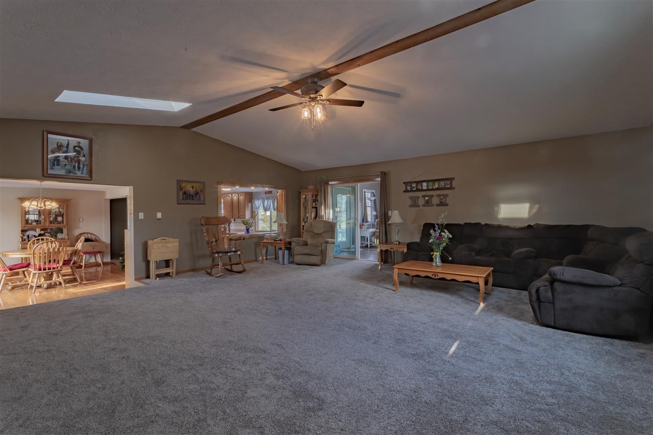 9119 Montague Road Winnebago, IL 61088 - Photo 12 of 36 a living room with furniture and a ceiling fan
