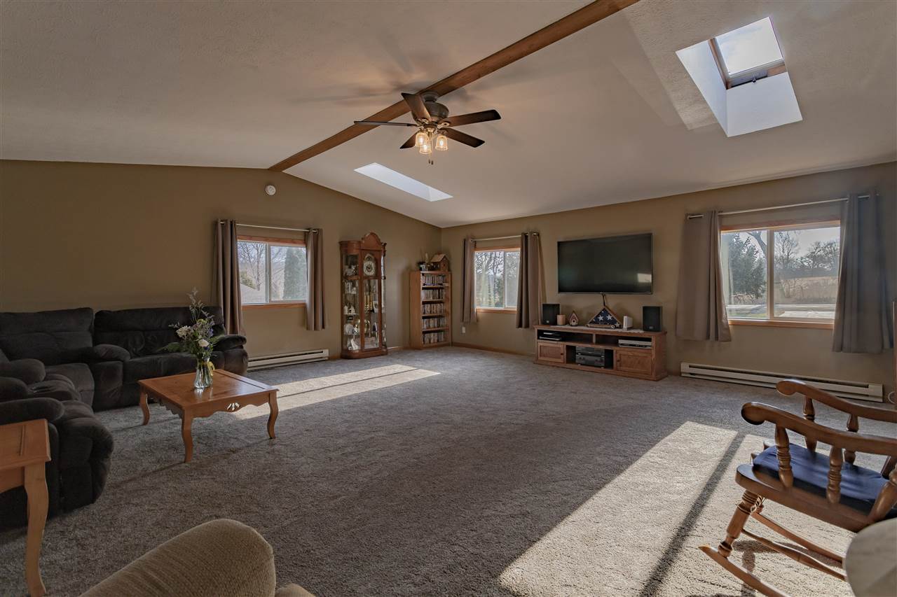 9119 Montague Road Winnebago, IL 61088 - Photo 13 of 36 a living room with furniture and a flat screen tv