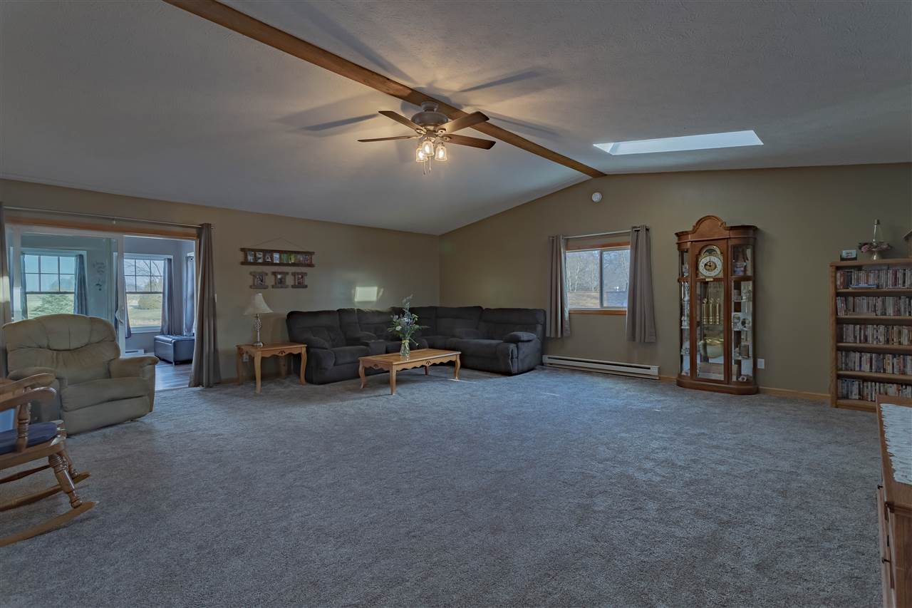 9119 Montague Road Winnebago, IL 61088 - Photo 14 of 36 a living room with furniture and a large window