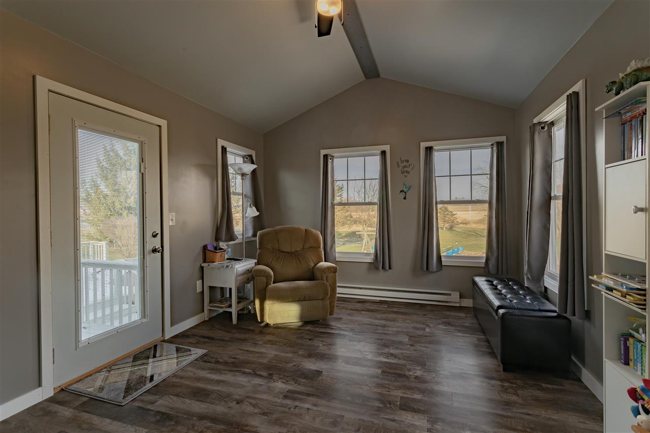 9119 Montague Road Winnebago, IL 61088 - Photo 16 of 36 a living room with furniture and a flat screen tv