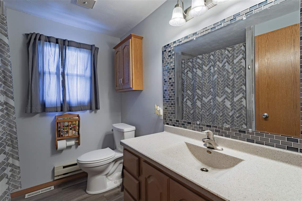 9119 Montague Road Winnebago, IL 61088 - Photo 22 of 36 a bathroom with a sink a toilet and mirror