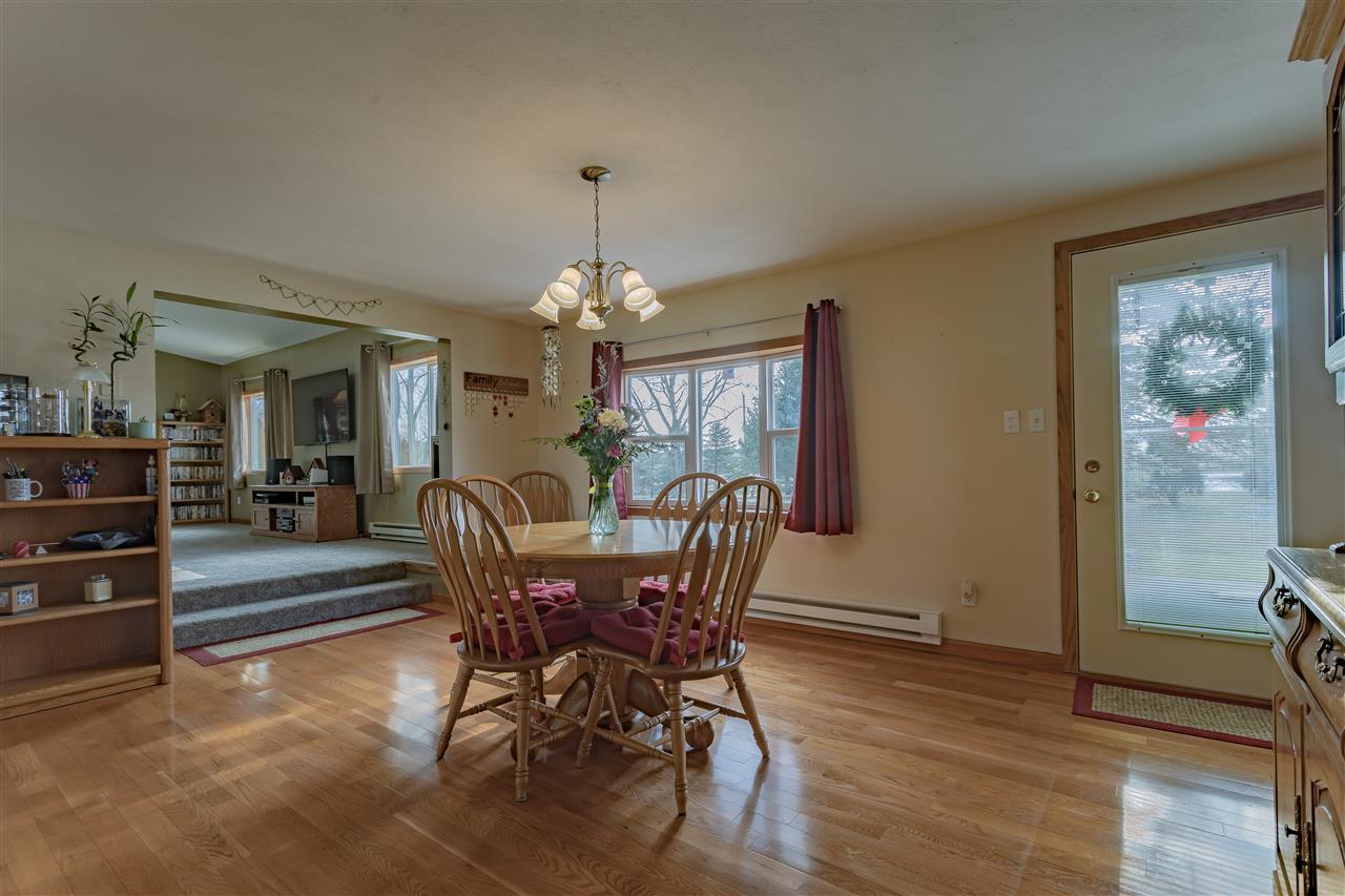 9119 Montague Road Winnebago, IL 61088 - Photo 3 of 36 a dining room with furniture a chandelier and wooden floor