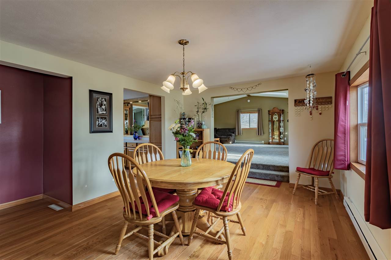 9119 Montague Road Winnebago, IL 61088 - Photo 5 of 36 a dining room with furniture a chandelier and wooden floor