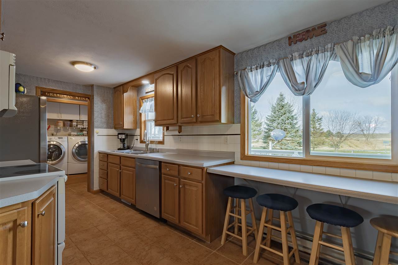 9119 Montague Road Winnebago, IL 61088 - Photo 8 of 36 a kitchen with a sink cabinets and window