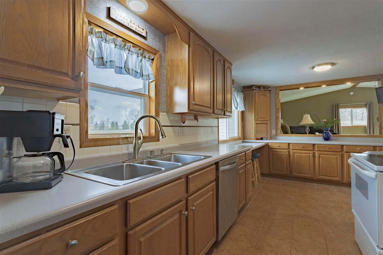9119 Montague Road Winnebago, IL 61088 - Photo 9 of 36 a kitchen with a sink and cabinets