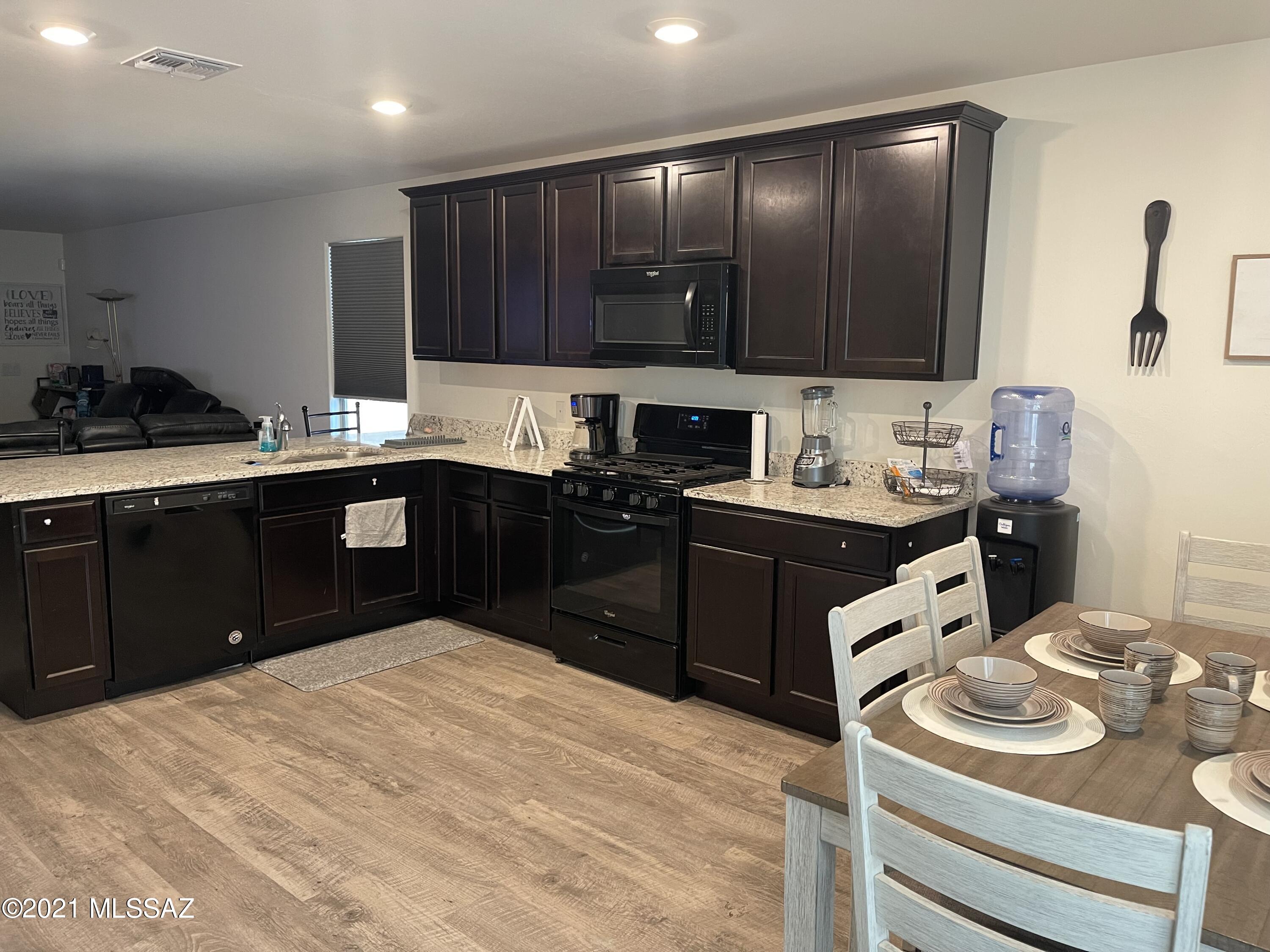 5992 South Antrim Loop Tucson, AZ 85706 - Photo 3 of 15 a kitchen with a sink stove and cabinets