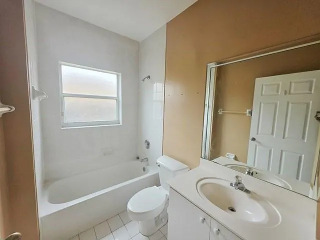 a bathroom with a sink a toilet a mirror and shower