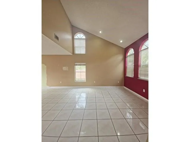 a view of an empty room with windows