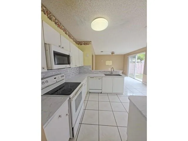 a kitchen with a sink cabinets and appliances