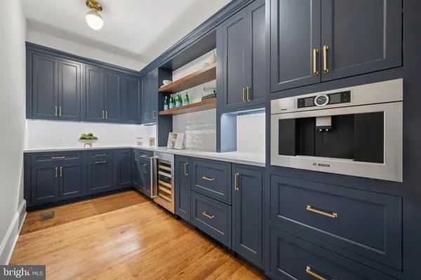 a kitchen with stainless steel appliances granite countertop a stove a microwave and wooden cabinets