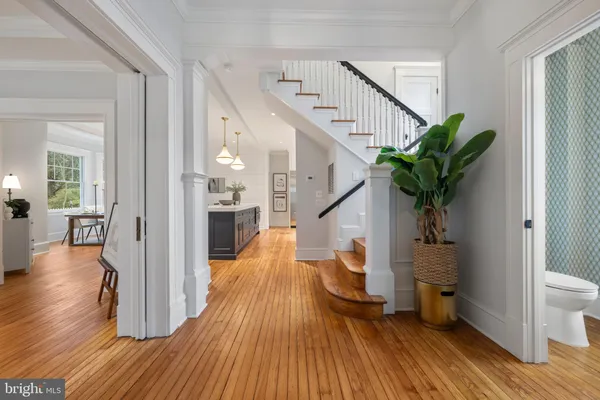 a view of entryway and hall with wooden floor