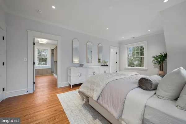 a spacious bedroom with a large bed and wooden floor