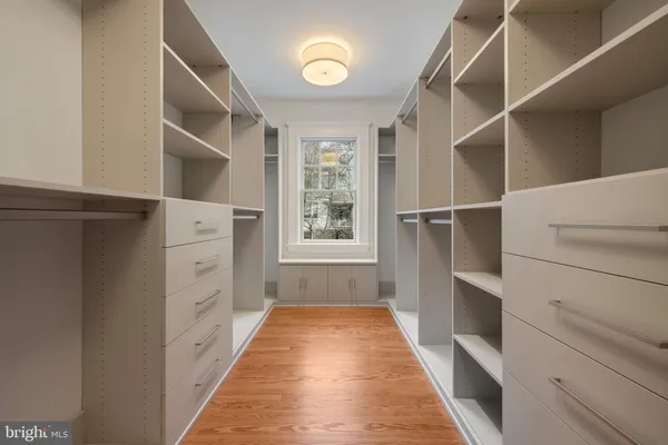 a hallway with cabinets and wooden floor