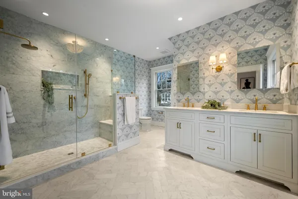 a spacious bathroom with a shower sink and mirror