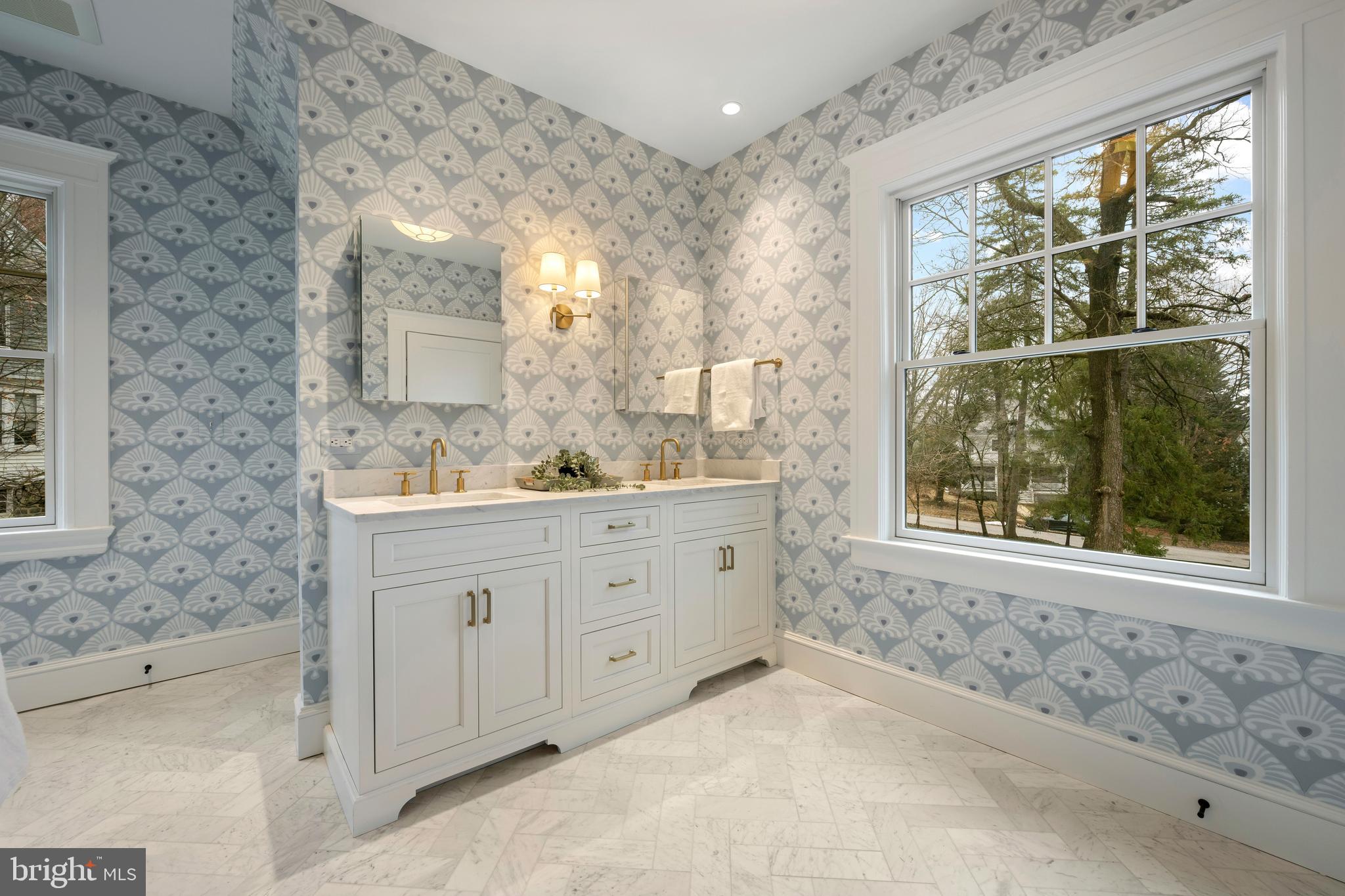 520 Woodlawn Road Baltimore, MD 21210 - Photo 23 of 39 a bathroom with a sink a mirror and a bathtub next to a window