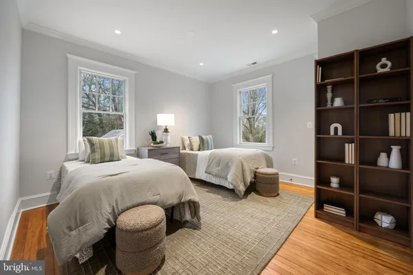 a bedroom with furniture and a book shelf
