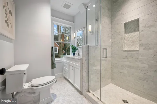 a bathroom with a toilet sink and shower