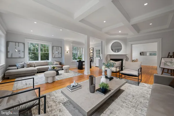 a living room with fireplace furniture and a large window