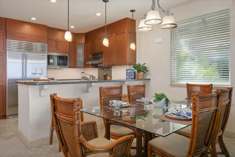 a dining room with furniture a chandelier and window