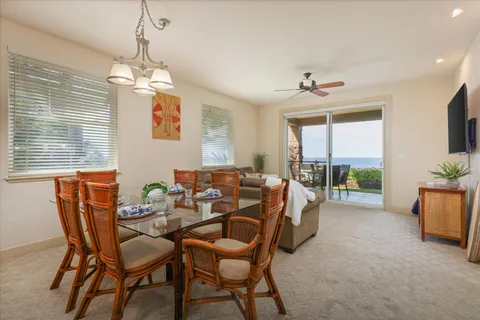 a dining room with furniture a chandelier and window