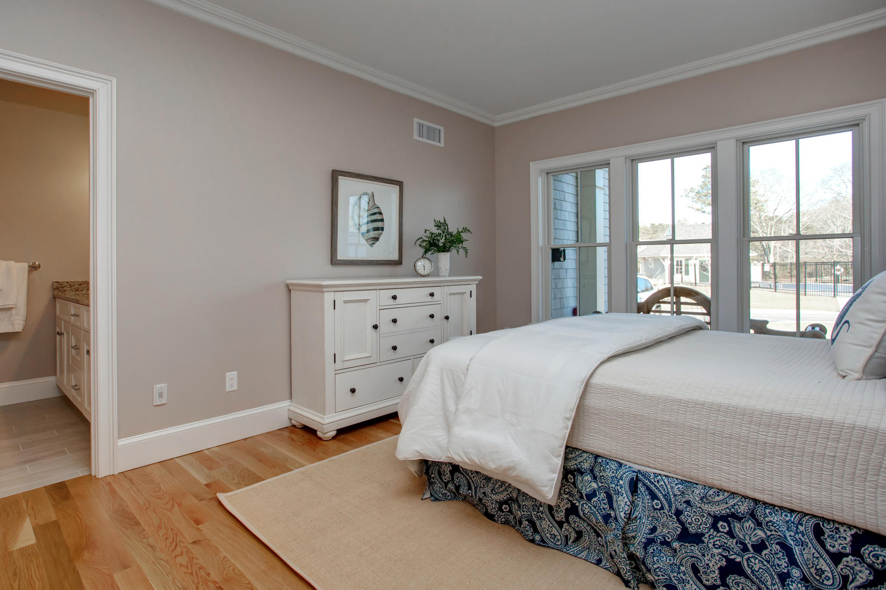 1090 Shore Road, Unit 10 Pocasset, MA 02559 - Photo 3 of 29 a bedroom with a bed and a dresser
