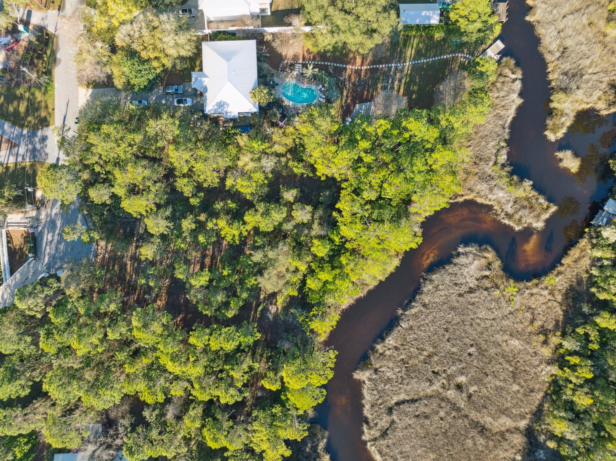 Lot 5 West Shore Dr Inlet Beach Inlet Beach, FL 32461 - Photo 7 of 32 a aerial view of a house with a yard and flowers