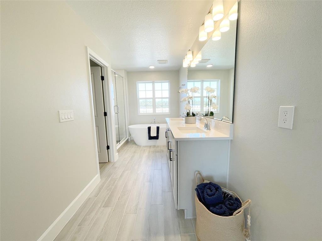 5261 High Line Drive St. Cloud, FL 34771 - Photo 11 of 39 a bathroom with a sink a toilet a mirror and window