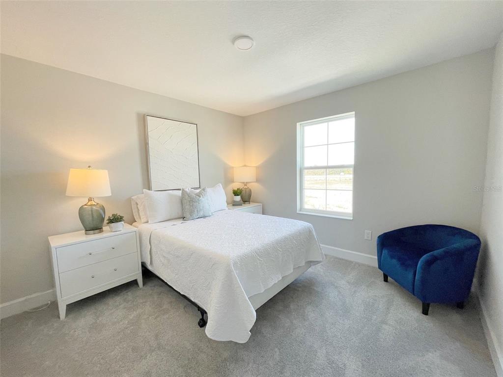 5261 High Line Drive St. Cloud, FL 34771 - Photo 13 of 39 a spacious bedroom with a bed and a dresser