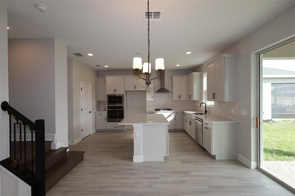 5261 High Line Drive St. Cloud, FL 34771 - Photo 16 of 39 a kitchen with a sink and a stove top oven