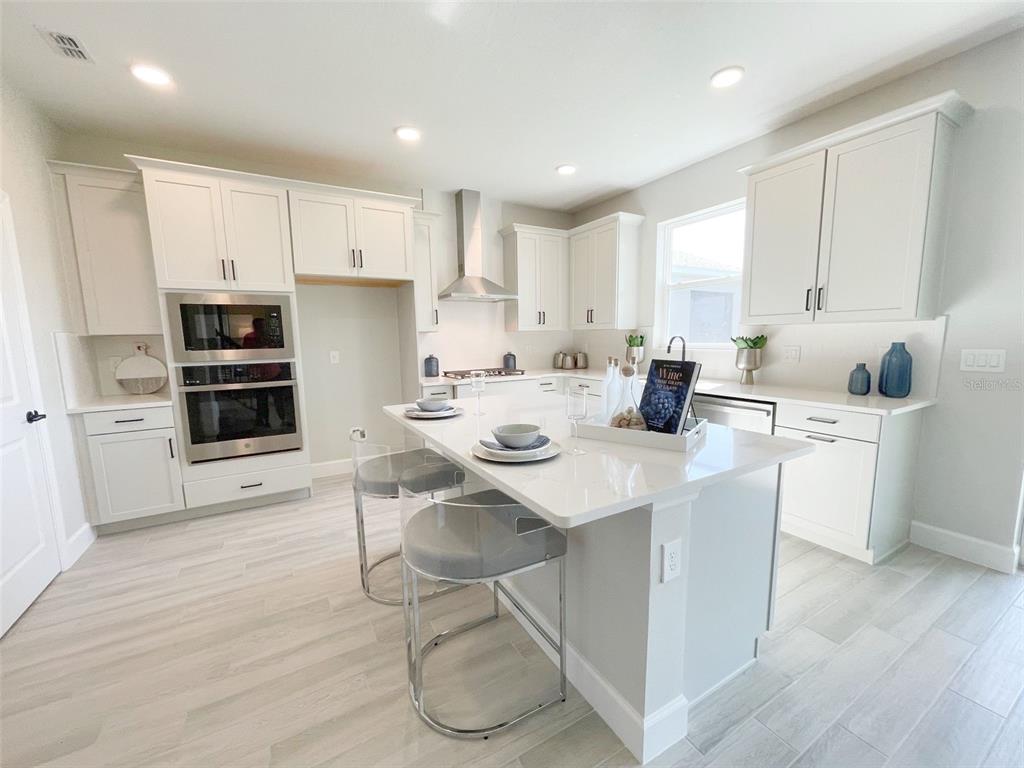 5261 High Line Drive St. Cloud, FL 34771 - Photo 2 of 39 a kitchen with a sink cabinets and wooden floor