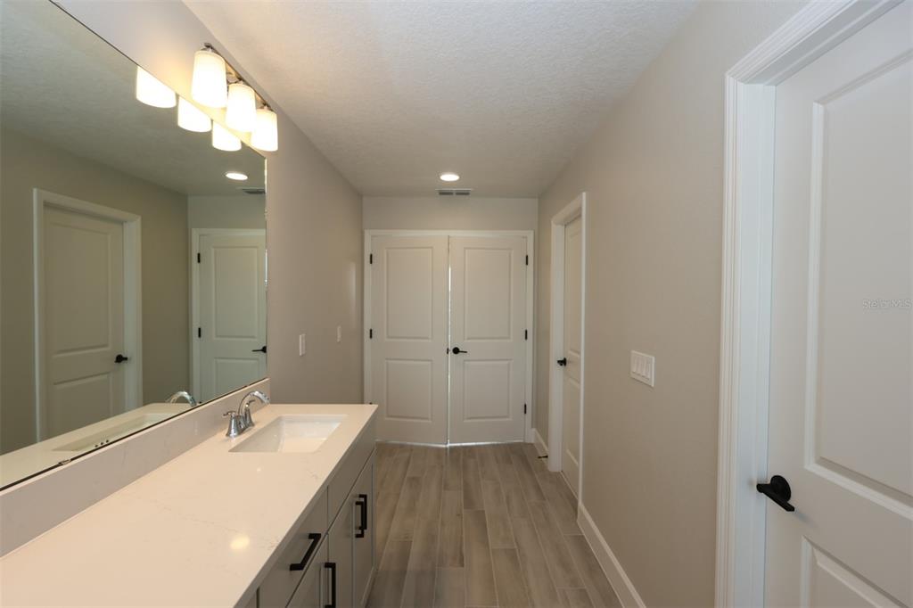 5261 High Line Drive St. Cloud, FL 34771 - Photo 23 of 39 a spacious bathroom with a double vanity sink and a mirror
