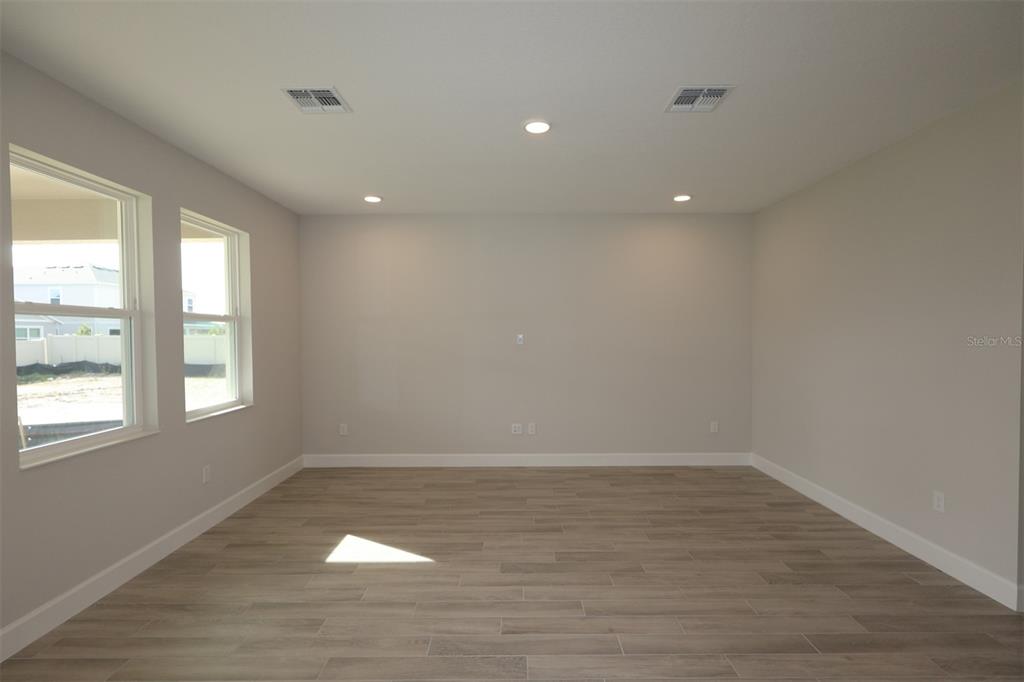 5261 High Line Drive St. Cloud, FL 34771 - Photo 31 of 39 an empty room with wooden floor and windows