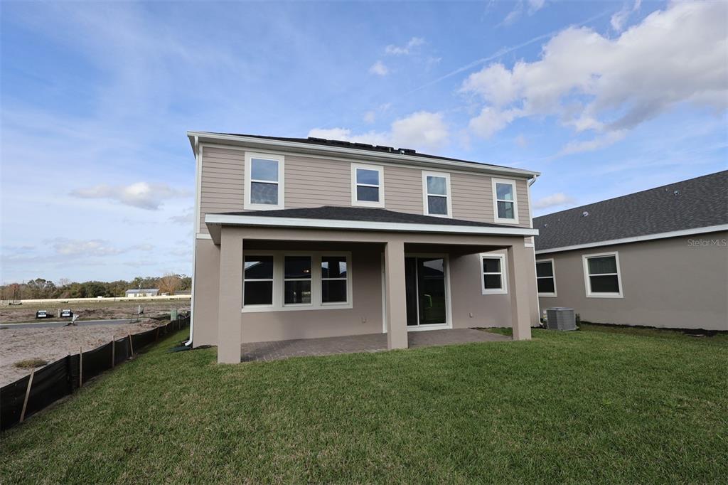 5261 High Line Drive St. Cloud, FL 34771 - Photo 35 of 39 a front view of a house with a garden