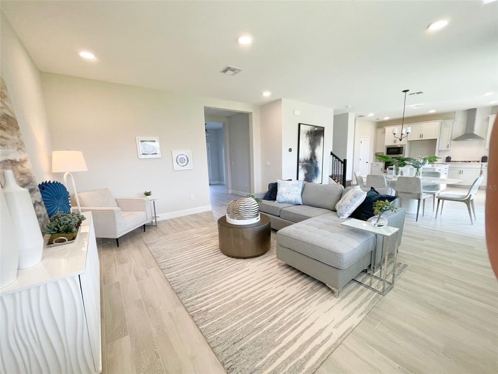 5261 High Line Drive St. Cloud, FL 34771 - Photo 8 of 39 a living room with furniture or chandelier and a wooden floor