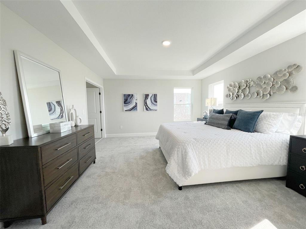 5261 High Line Drive St. Cloud, FL 34771 - Photo 9 of 39 a spacious bedroom with a bed and a dresser