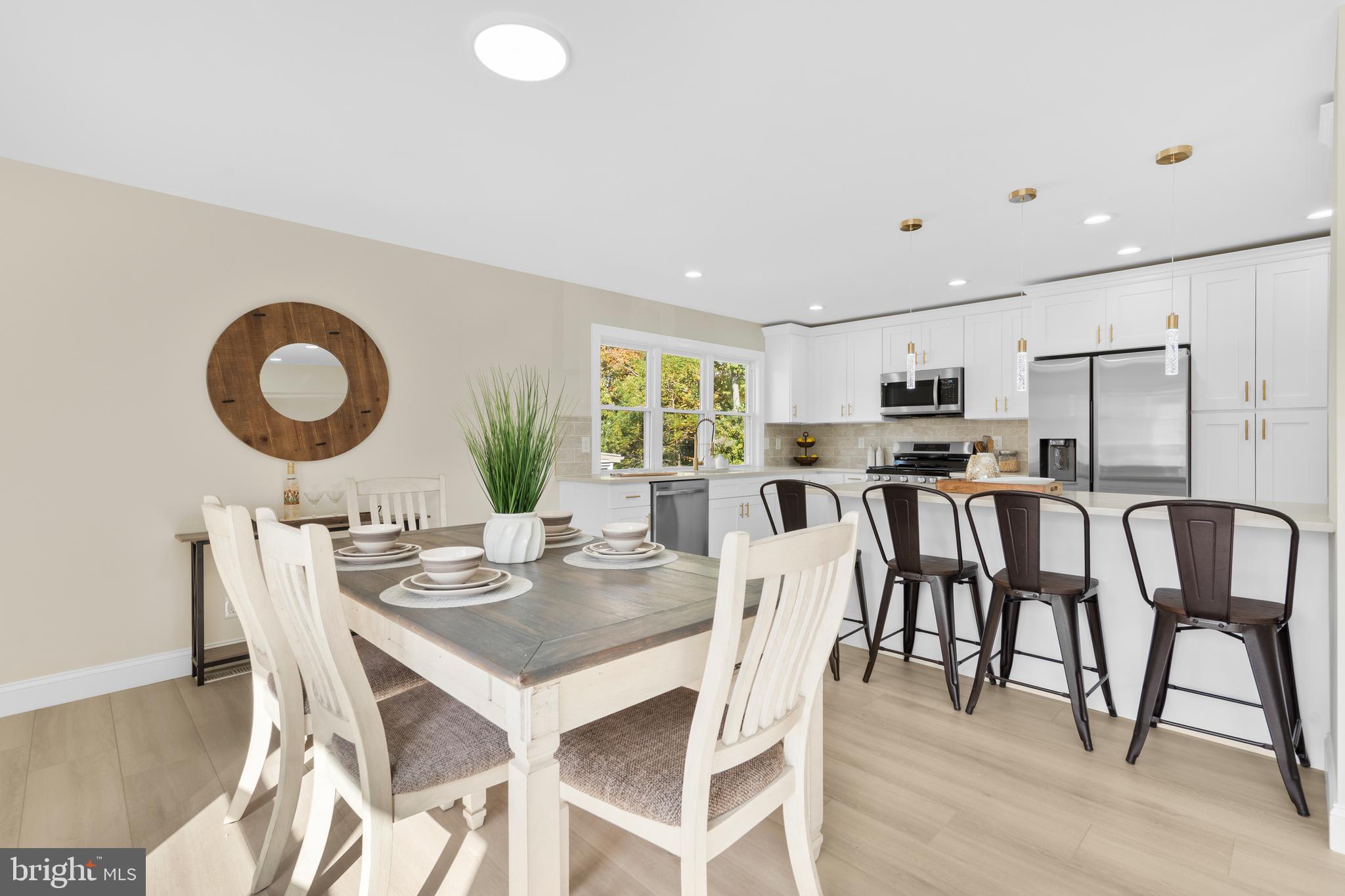 120 Canterbury Road Mount Laurel, NJ 08054 - Photo 12 of 46 a kitchen with stainless steel appliances granite countertop a dining table chairs stove and white cabinets