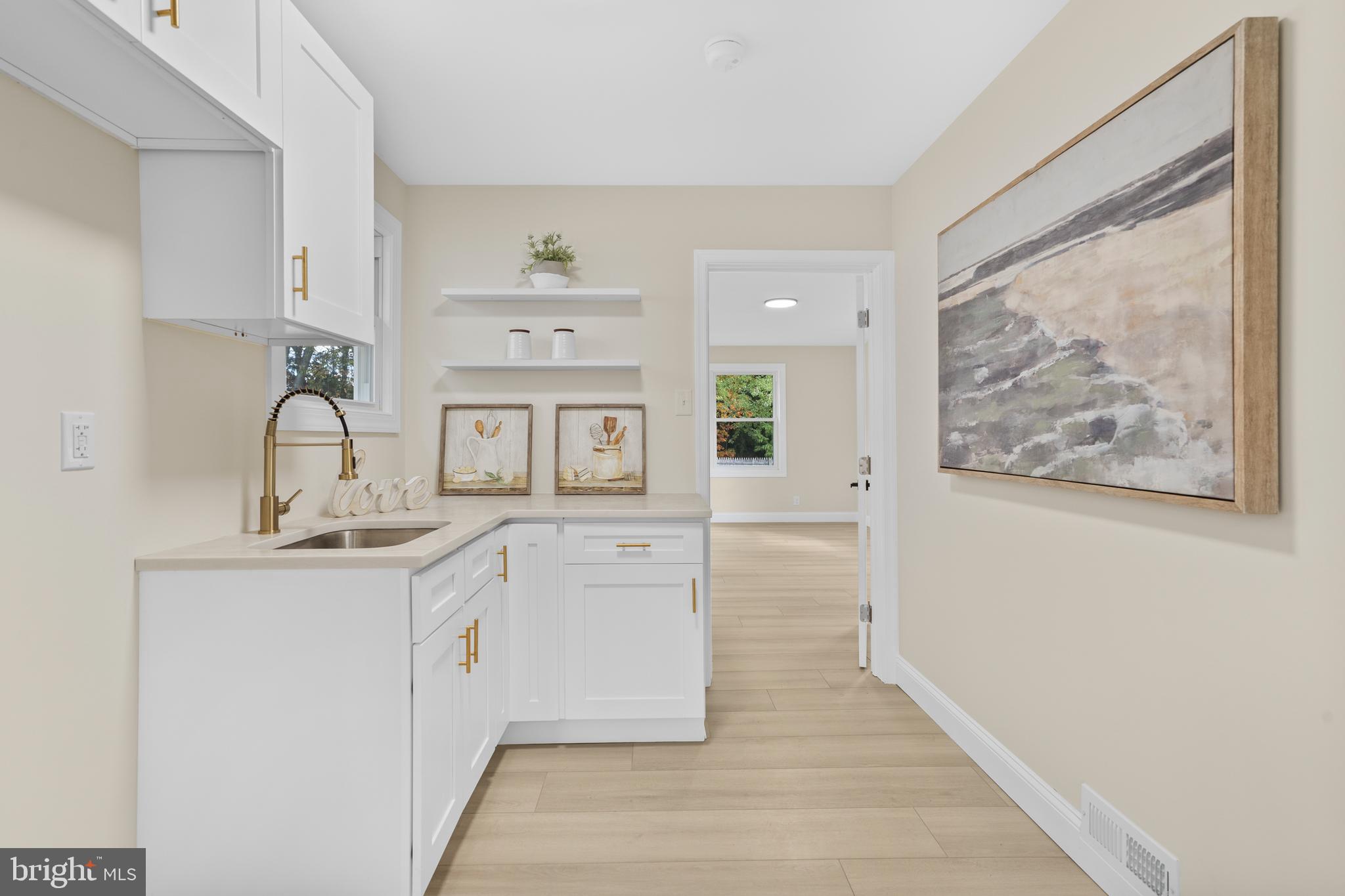 120 Canterbury Road Mount Laurel, NJ 08054 - Photo 36 of 46 a room with cabinets a sink and a painting on the wall