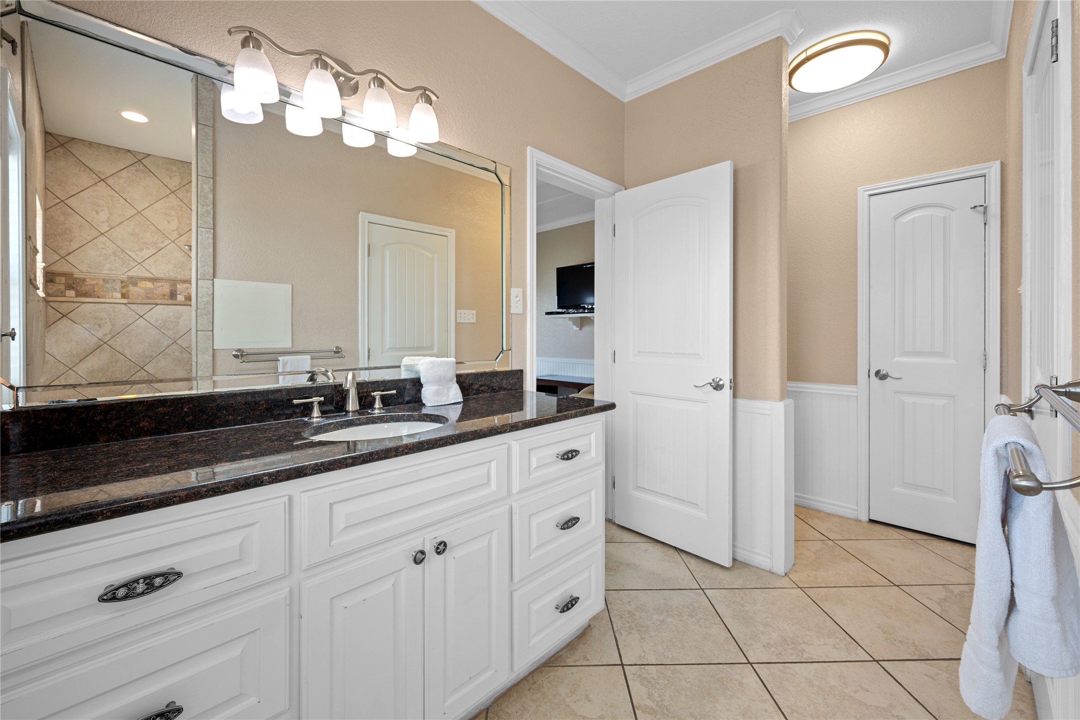 740 Copano Cove Road Rockport, TX 78382 - Photo 25 of 35 a spacious bathroom with a granite countertop sink a mirror and a shower