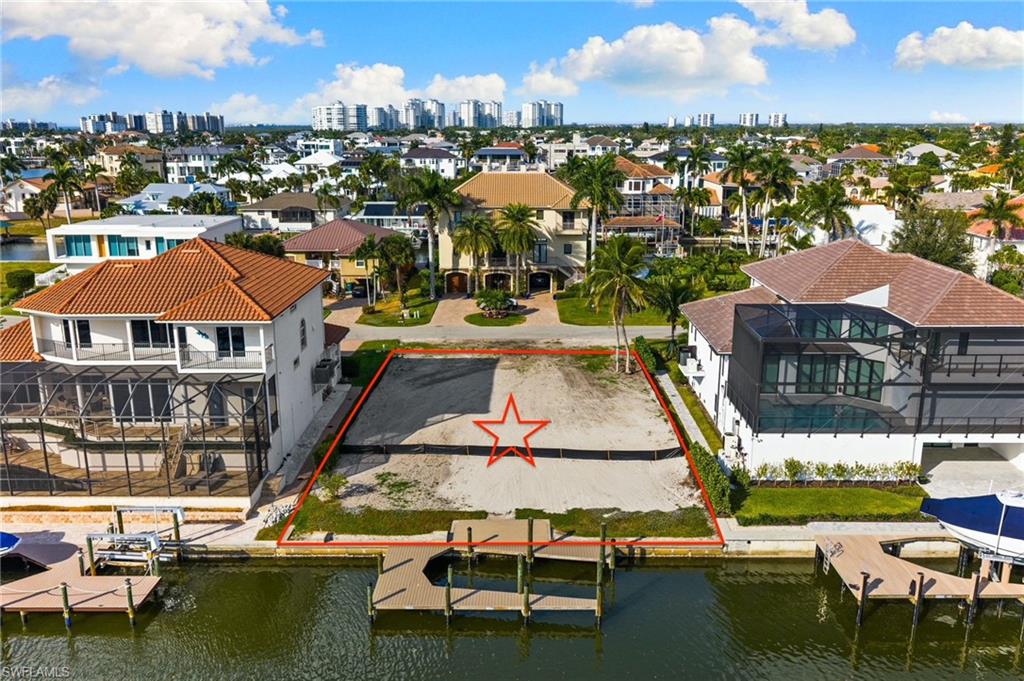 418 Seagull Avenue Naples, FL 34108 - Photo 14 of 36 a view of a lake with a table and chairs