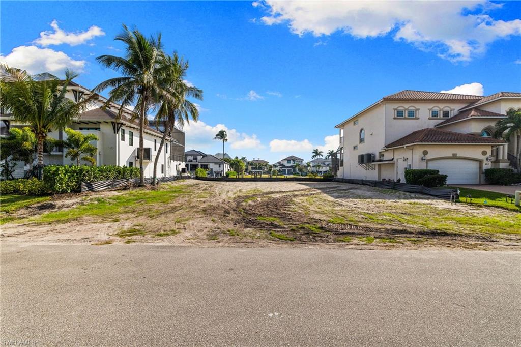 418 Seagull Avenue Naples, FL 34108 - Photo 16 of 36 a view of a house with a swimming pool and a yard