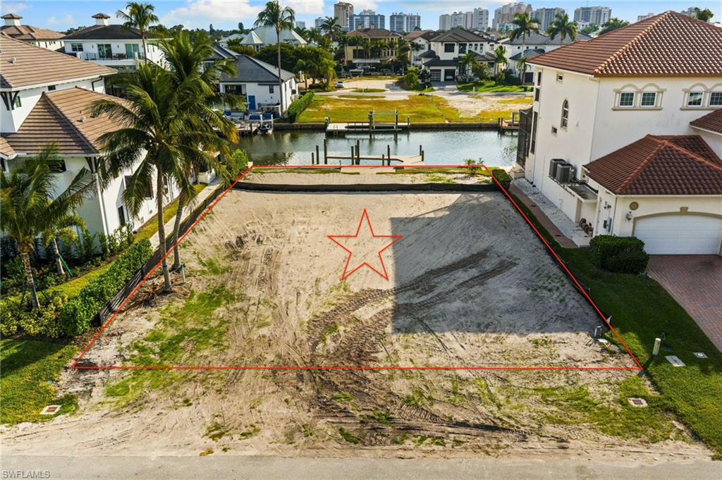 418 Seagull Avenue Naples, FL 34108 - Photo 2 of 36 a view of a swimming pool with an outdoor space and seating area