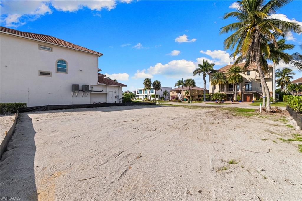 418 Seagull Avenue Naples, FL 34108 - Photo 21 of 36 a view of a road with a building in the background