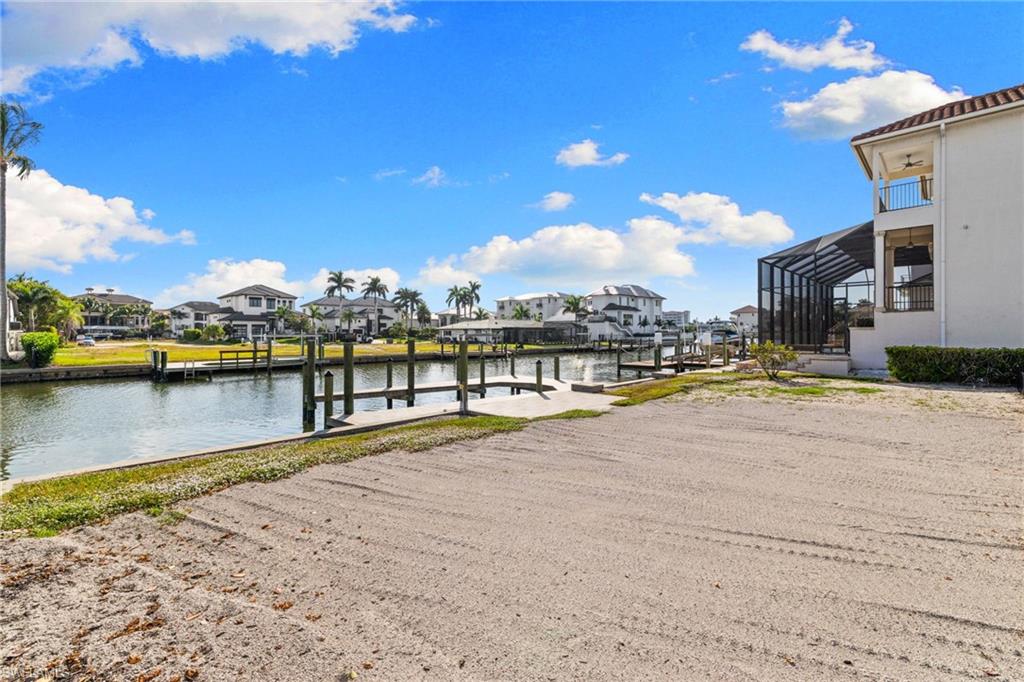 418 Seagull Avenue Naples, FL 34108 - Photo 22 of 36 a view of a lake with houses