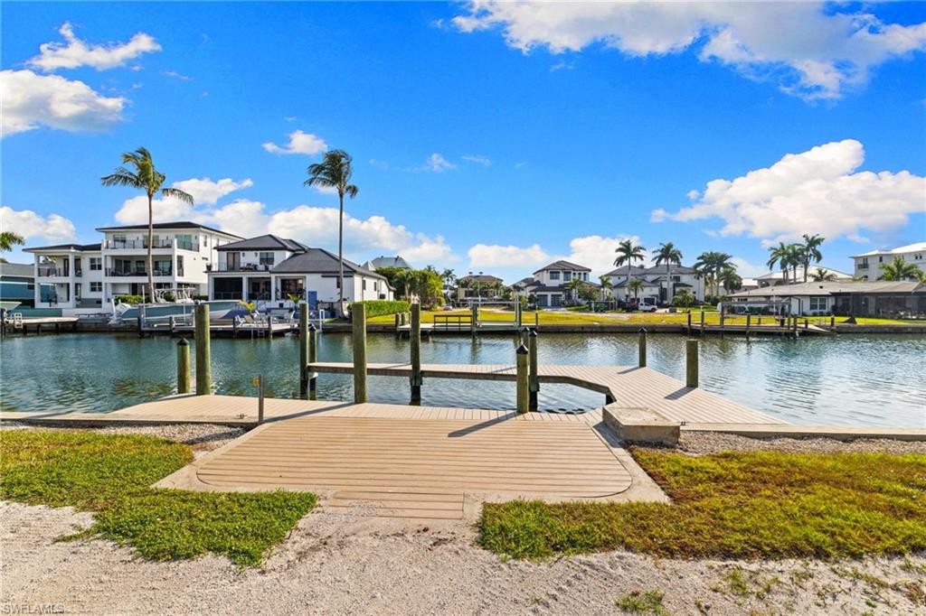 418 Seagull Avenue Naples, FL 34108 - Photo 27 of 36 a view of a lake with a house