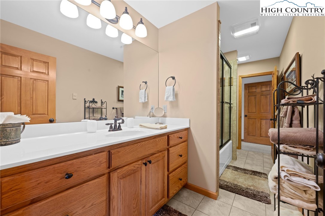295 Supreme Golden Road Banner Elk, NC 28604 - Photo 23 of 40 a bathroom with a sink a vanity and a mirror