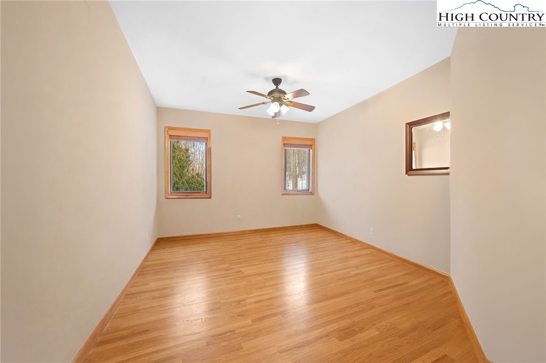 295 Supreme Golden Road Banner Elk, NC 28604 - Photo 24 of 40 wooden floor in an empty room with a window