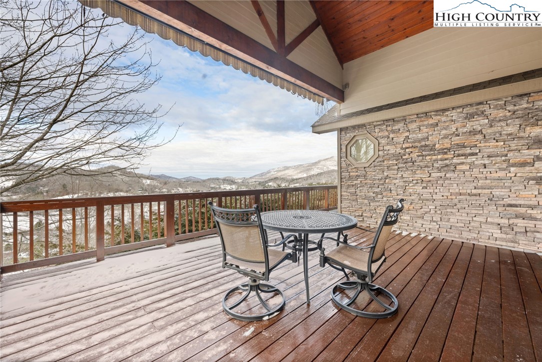 295 Supreme Golden Road Banner Elk, NC 28604 - Photo 27 of 40 a view of a balcony with wooden floor and outdoor seating
